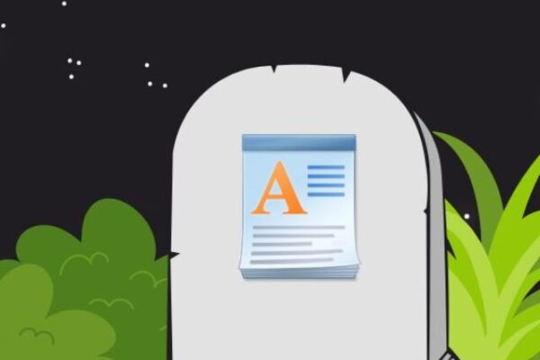 Imagem de uma lápide cinza com o ícone do Microdoft Wordpad em um terreno com algumas vegetações e um céu estrelado, indicando ser um cemitério.